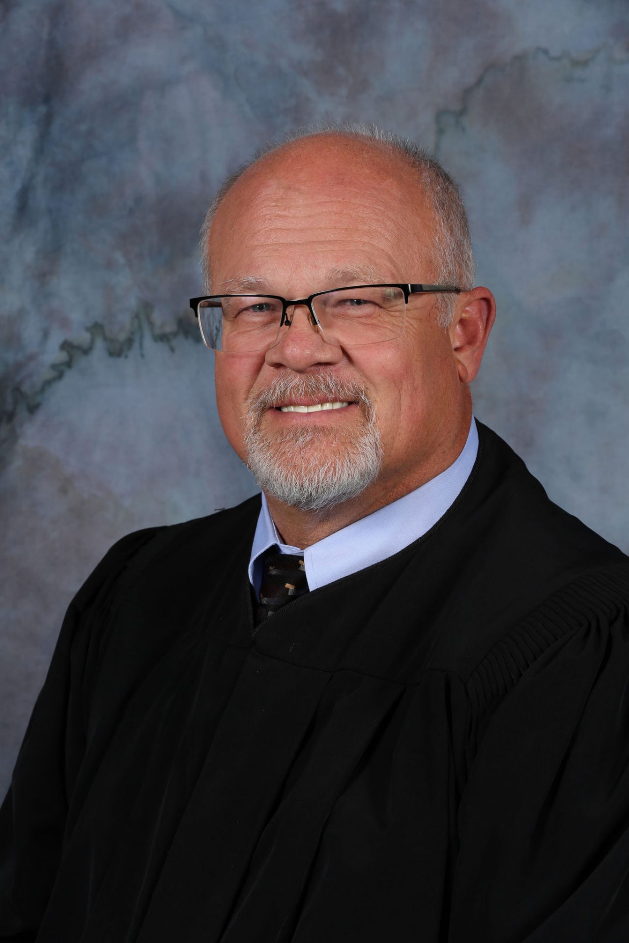 Portrait of Judge Randy B Birch in his judicial robe, smiling